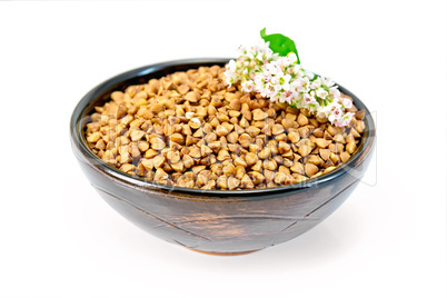 Buckwheat in brown bowl and flower