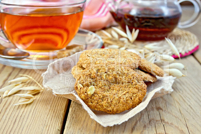 Cookies oatmeal with spikelet and napkin on board