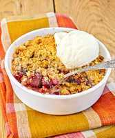 Crumble cherry in bowl with ice cream on board