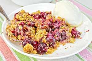 Crumble cherry in plate on tablecloth