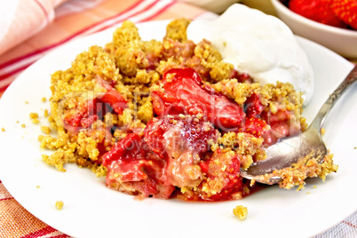 Crumble strawberry in plate with spoon on napkin