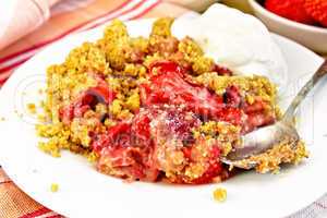 Crumble strawberry in plate with spoon on napkin