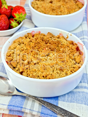 Crumble strawberry on blue napkin with berries