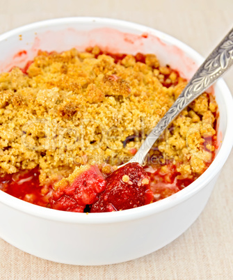Crumble strawberry with spoon on fabric