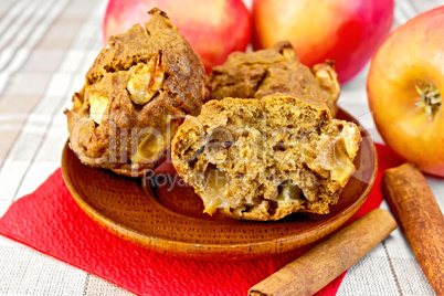 Cupcakes rye with apples in wooden plate on tablecloth