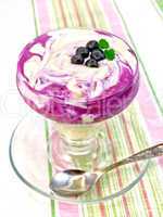 Dessert milk with blueberries on striped tablecloth