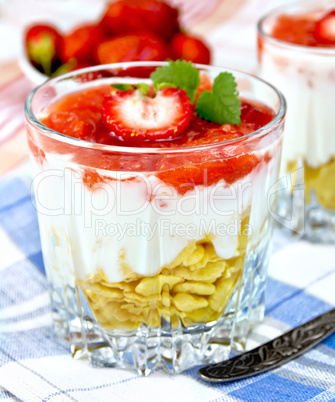 Dessert milk with strawberry and flakes in glass on napkin