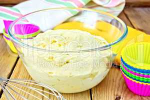 Dough for cupcakes with molds on board