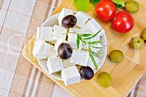 Feta with olives in bowl on fabric