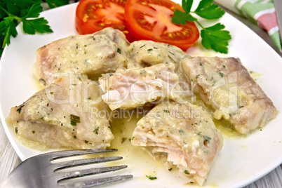 Fish stew with cream sauce in plate on board