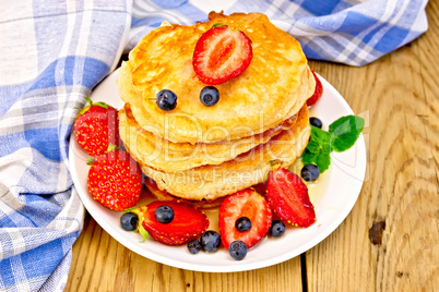 Flapjacks with strawberries and blueberries on board