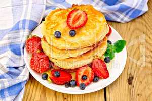Flapjacks with strawberries and blueberries on board