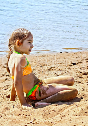 Girl on sand by the river