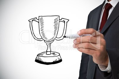 Composite image of businessman drawing winners cup