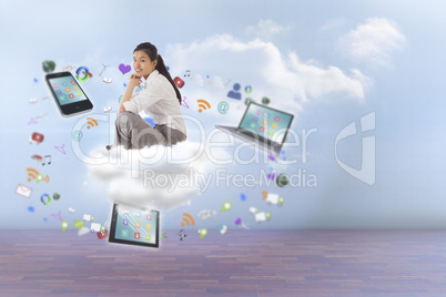 Composite image of businesswoman sitting cross legged with hands