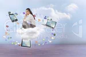 Composite image of businesswoman sitting cross legged with hands