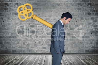 Composite image of wound up businessman with hands in pockets