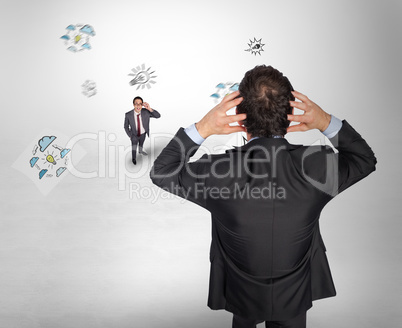 Composite image of stressed businessman with hands on head with