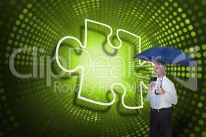 Composite image of jigsaw piece and businessman holding umbrella