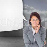 Composite image of smiling thoughtful businesswoman with speech