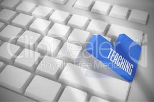 Teaching on white keyboard with blue key