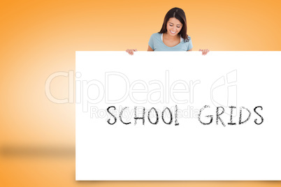 Pretty brunette showing card with school grids