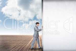 Composite image of businessman pushing away scene