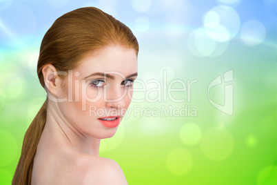 Composite image of beautiful redhead looking at camera