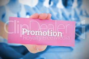 Woman holding pink card saying promotion