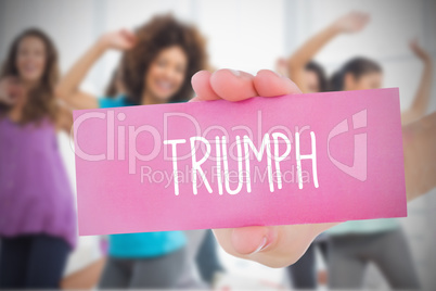 Woman holding pink card saying triumph