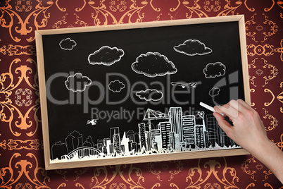 Composite image of hand drawing cityscape with chalk