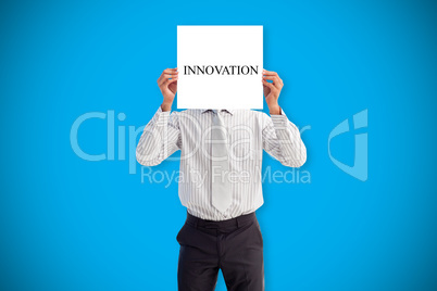 Businessman holding card saying innovation