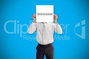 Businessman holding card saying innovation