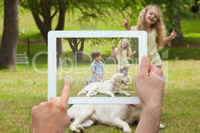 Composite image of hand holding tablet pc