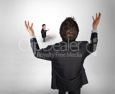 Composite image of gesturing businessman with tiny businessman