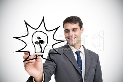 Composite image of businessman drawing light bulb