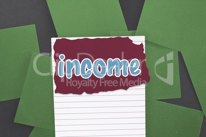Income against green paper strewn over black