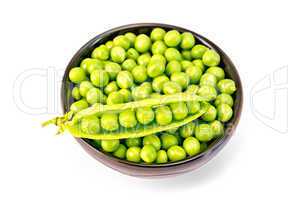 Green peas in brown bowl with pod