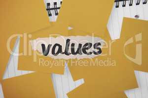 Values against yellow paper strewn over notepad