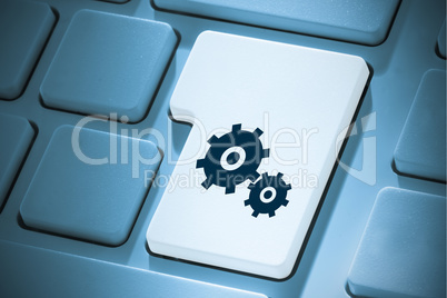 Composite image of cog and wheel on enter key