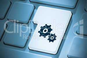 Composite image of cog and wheel on enter key