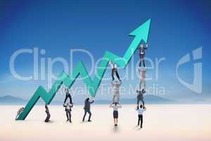 Composite image of business team holding up arrow