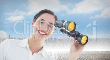 Composite image of smiling business woman with binoculars