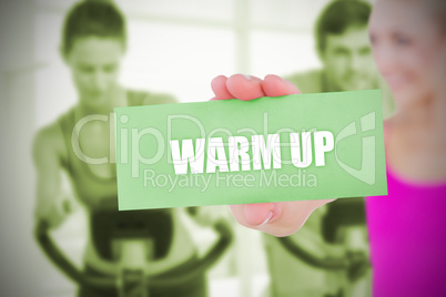 Fit blonde holding card saying warm up
