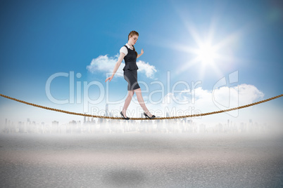 Composite image of businesswoman doing a balancing act