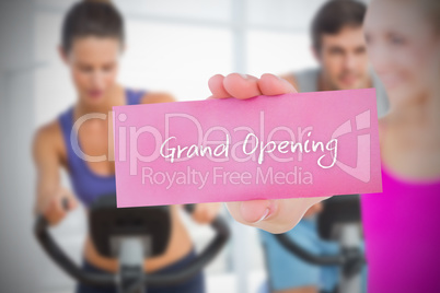 Fit blonde holding card saying grand opening
