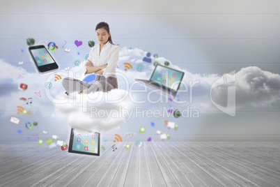 Composite image of annoyed businesswoman sitting with arms cross