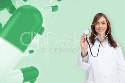 Composite image of happy doctor using stethoscope