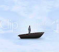 Composite image of businessman standing in a sailboat