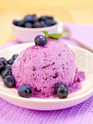 Ice cream blueberry in bowl on purple napkin
